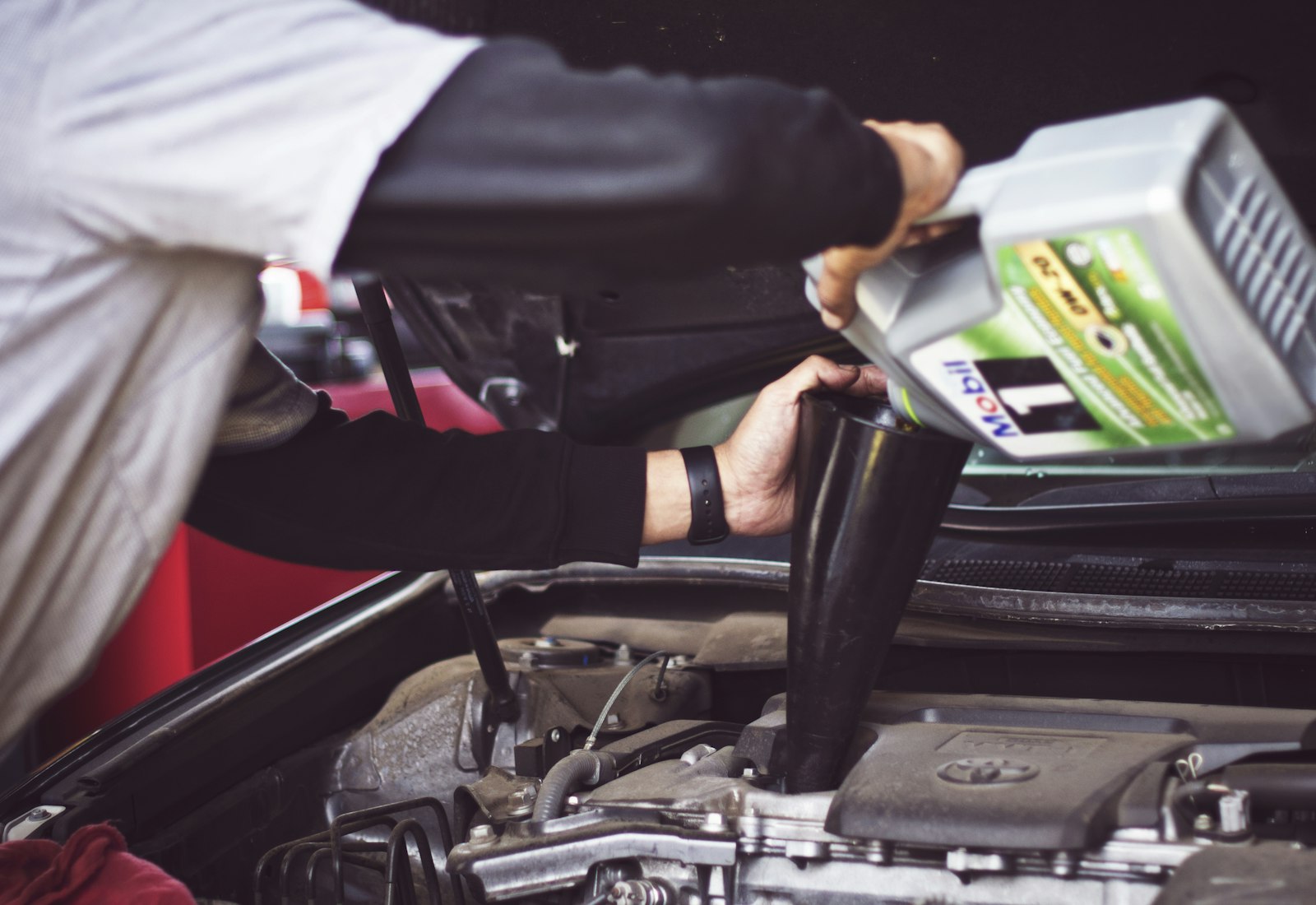 Kalum Tire technician working under the hood of a vehicle in the Terrace shop